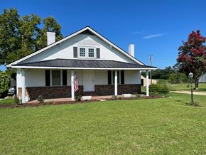Benson house for rent - a white house with an flag in the front yard
