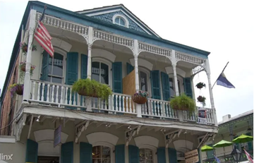 New Orleans house for rent - a house with a balcony and an flag on it