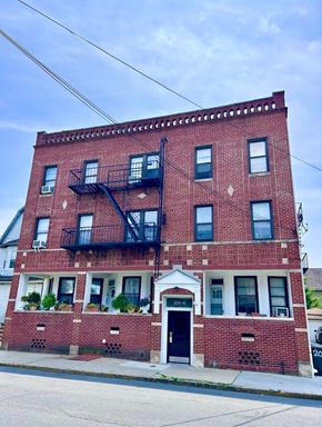 Bloomfield apartment for rent - A red brick building with a black fire escape.