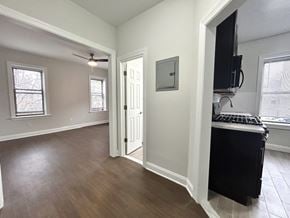 Bloomfield apartment for rent - A room with a black fridge and a television on the wall.