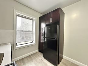 Bloomfield apartment for rent - A black refrigerator in a kitchen with a window.