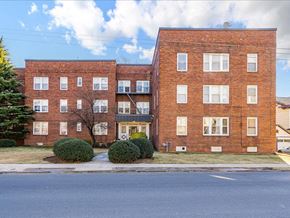 Hasbrouck Heights apartment for rent - A red brick building with a tree in front.