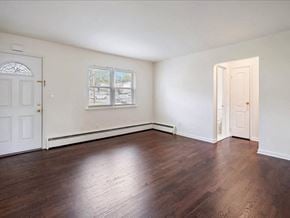 Englewood apartment for rent - A room with wooden floors and white walls.