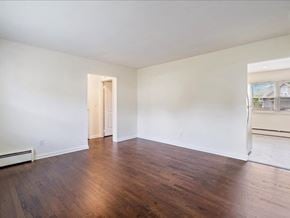 Englewood apartment for rent - A room with wooden floors and white walls.