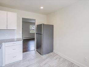 Englewood apartment for rent - A kitchen with a refrigerator, countertop, and cabinets.