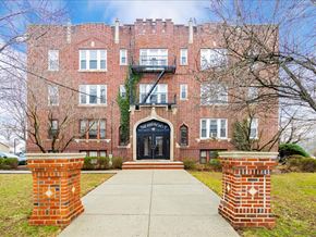 Somerville apartment for rent - A red brick building with a black door and windows.