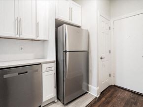 Somerville apartment for rent - A kitchen with a refrigerator, dishwasher, and cabinets.