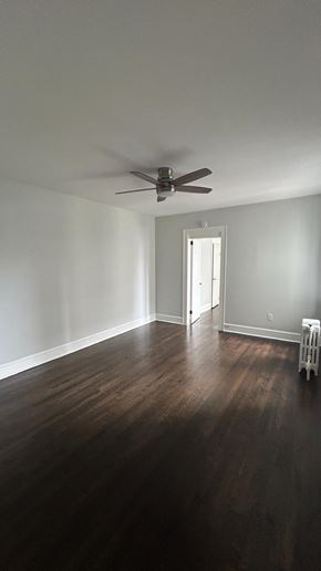 Bergenfield apartment for rent - A room with a ceiling fan and a wooden floor.