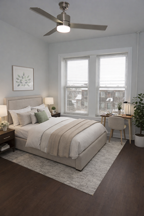 Bayonne apartment for rent - A bedroom with a large bed and a ceiling fan.