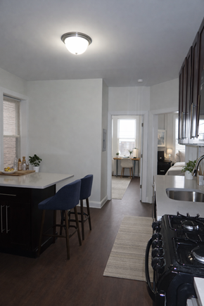 Bayonne apartment for rent - A kitchen with a black stove top oven and a white counter top.