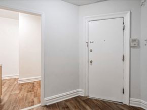 Bayonne apartment for rent - A white door is in a room with wood floors and white walls.