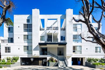 Los Angeles apartment for rent - A white modern apartment building with a tree in front.