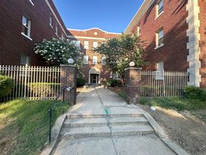 Washington apartment for rent - an alleyway between two brick buildings and a fence