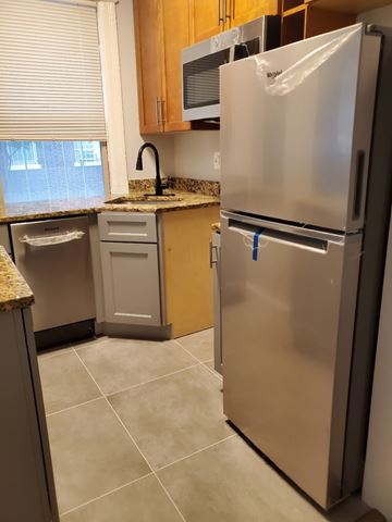 Washington apartment for rent - a kitchen with a stainless steel refrigerator and a sink