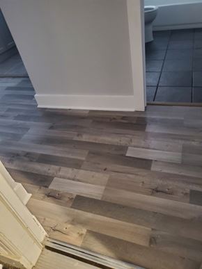 Washington apartment for rent - a hardwood floor in a room with a door and a tile floor