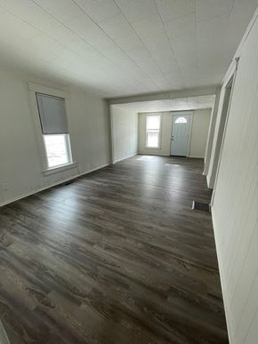 Lima apartment for rent - A room with wooden floors and white walls.
