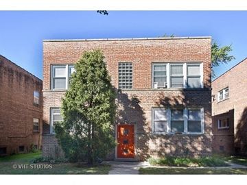Evanston apartment for rent - a brick building with a red door and a tree