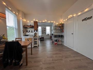 Chicago apartment for rent - A kitchen with wooden floors and a dining table with chairs.