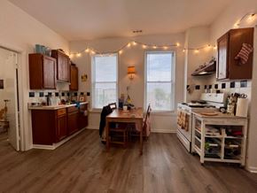 Chicago apartment for rent - A kitchen with wooden floors and a table with chairs.