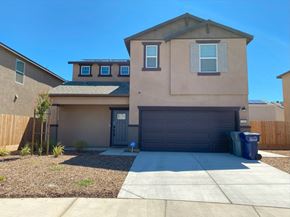Merced house for rent - A two-story house with a garage and a driveway.