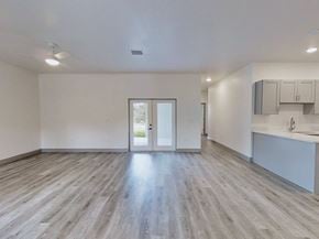 Ocklawaha house for rent - A spacious room with a kitchen area in the background.