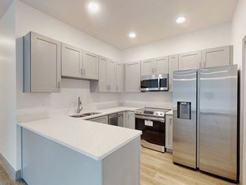 Ocklawaha house for rent - A kitchen with a white counter and stainless steel appliances.