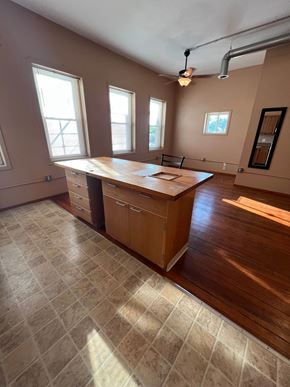 Grinnell apartment for rent - an empty living room with an island in the middle of it
