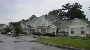 Havelock apartment for rent - a row of houses with cars parked in a parking lot