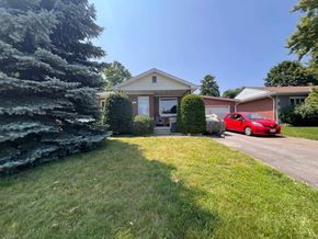 Kitchener apartment for rent - a house with a red car parked in front of it