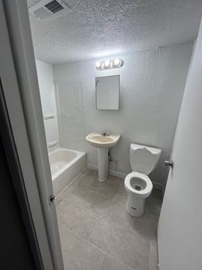 Cleveland apartment for rent - A white toilet and sink in a small bathroom.