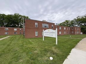 Cleveland apartment for rent - A sign for "Nolacrest Gardens" stands in front of a brick building.