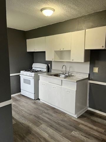 Cleveland apartment for rent - A kitchen with white appliances and cabinets.