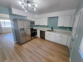 Palm Desert apartment for rent - a renovated kitchen with stainless steel appliances and white cabinets