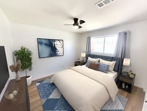 Palm Desert apartment for rent - a bedroom with a bed and a ceiling fan