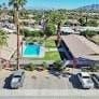 Palm Desert apartment for rent - an aerial view of a house with a pool and cars in the street