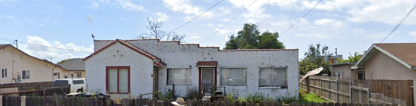 Santa Maria apartment for rent - A white house with a red door is surrounded by a fence.