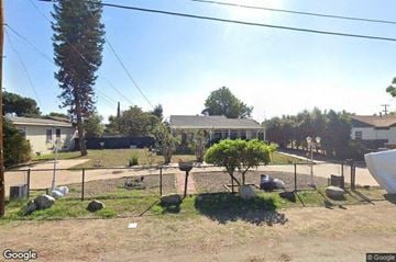 Lemon Grove house for rent - A backyard with a fence, a tree, and a small shrub.