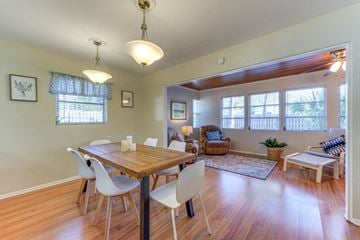 Sarasota house for rent - a dining room and living room with a table and chairs
