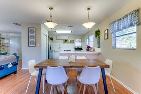Sarasota house for rent - a dining room and kitchen with a table and chairs