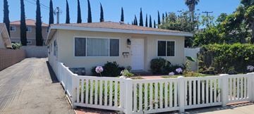 Lomita apartment for rent - a small white house with a white fence in front of it