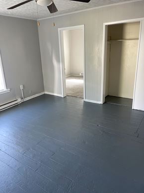 Lima apartment for rent - A room with a ceiling fan and two open doors.