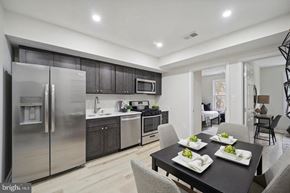 Washington apartment for rent - a kitchen with stainless steel appliances and a dining table