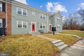 Washington apartment for rent - the front of a gray house with red doors