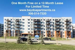 Saskatoon apartment for rent - A large apartment complex with a sign offering a free month on a 12-month lease.