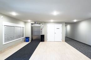 Saskatoon apartment for rent - A clean, empty office space with a trash bin and recycling bin.