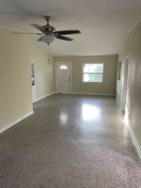 Orlando house for rent - A room with a ceiling fan and a door.