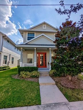 Orlando house for rent - A house with a red door and a small porch.