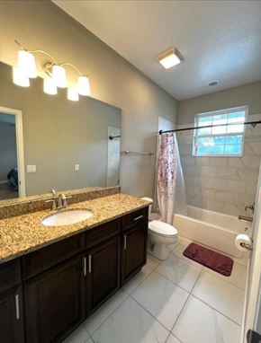 Orlando house for rent - A bathroom with a sink, toilet, and shower.