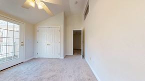 Pepperell apartment for rent - A room with a ceiling fan and carpeted floor.