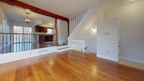 Pepperell apartment for rent - A room with wooden floors and a staircase.